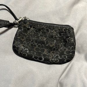 Black and silver coach wristlet.